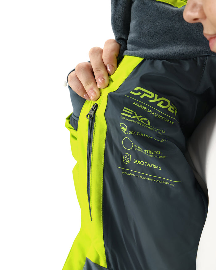 Close-up of a person wearing a Spyder jacket with visible branding and product features.