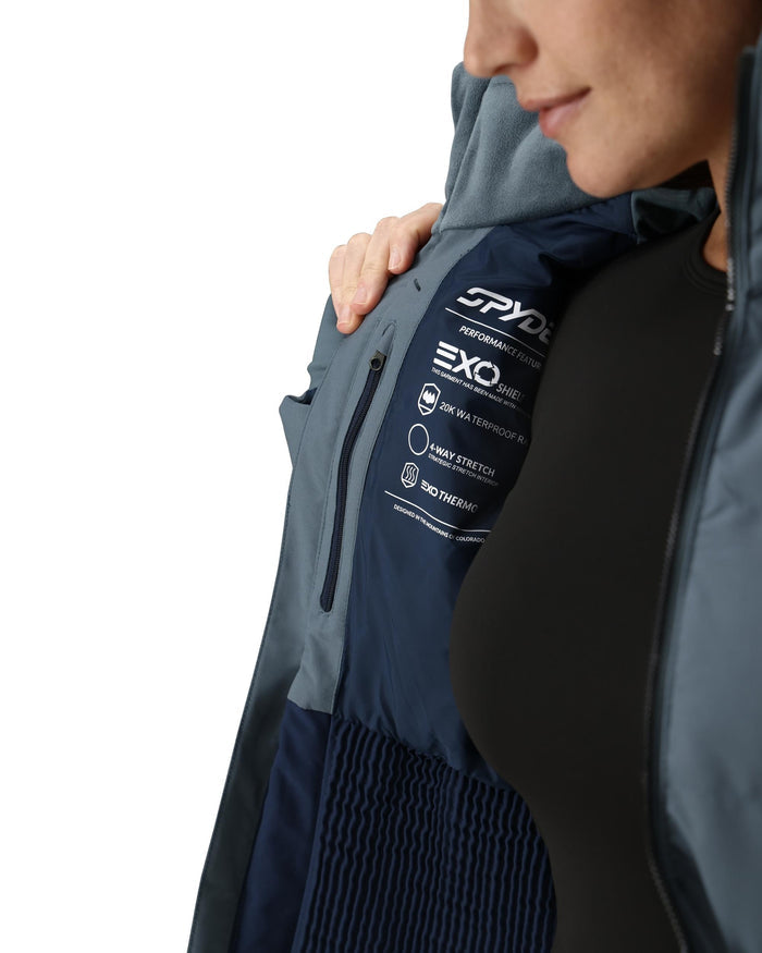 Person wearing a Spyder jacket with EXO technology on a white background